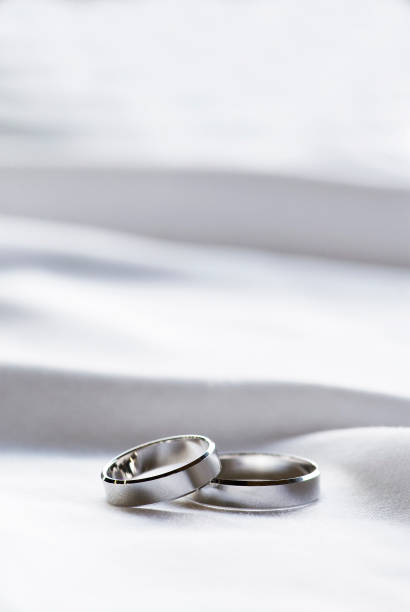 istock Couple wedding ring on fabric background 663980868