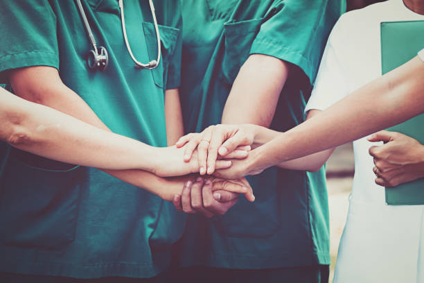 Doctors and nurses coordinate hands. Concept Teamwork stock photo