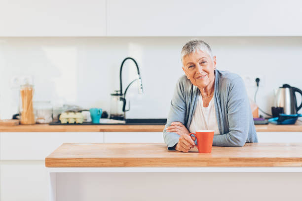 istock Beautiful senior woman in a domestic kitchen 663982108