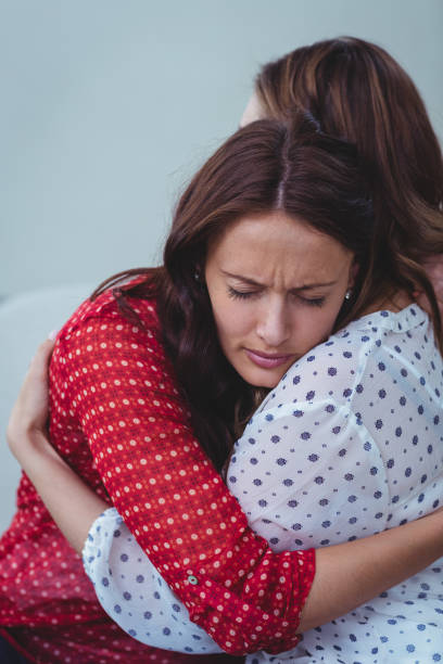 istock Depressed woman embracing her friend 663982124