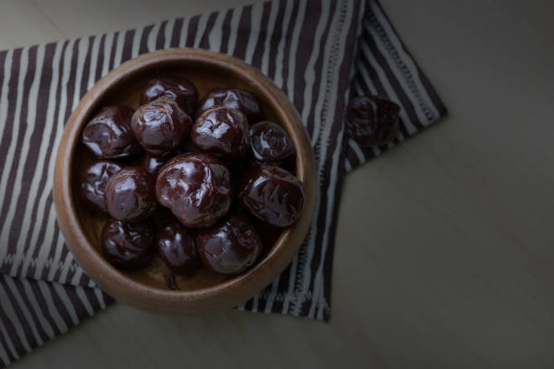 istock Dried plums on wood floor 663984884