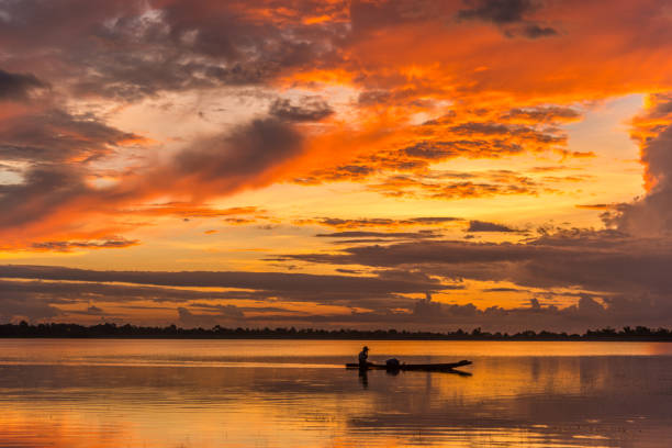 istock River view of sunset with fisherman 663985264
