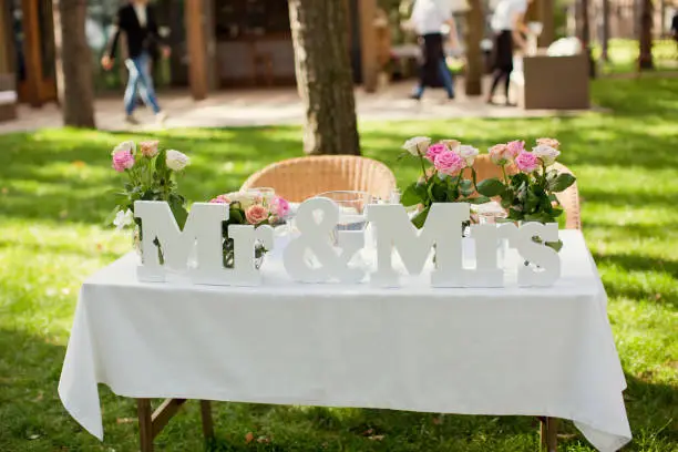 Beautifully decorated wedding table with flowers and MR and MRS letters