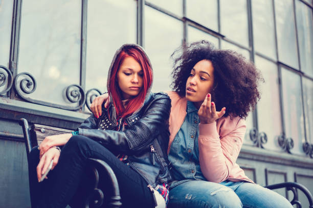 istock Young woman calming a depressed friend 663990974