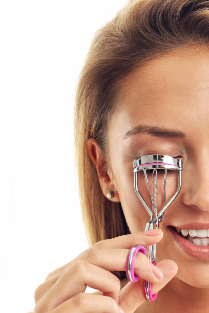istock Picture showing woman using eyelash curler over white 663994210