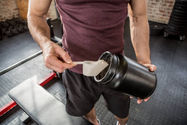 istock Midsection of man taking supplement from tin 663994288