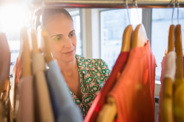 istock Woman selecting an apparel while shopping for clothes 663994898