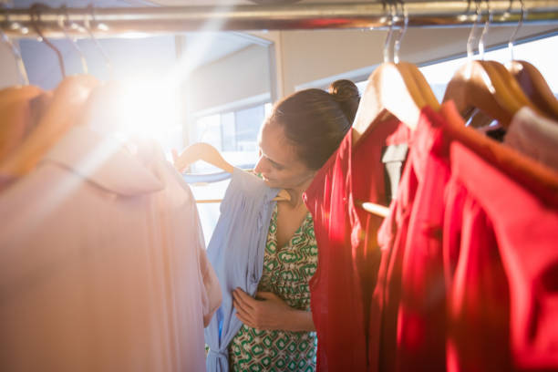 istock Woman selecting an apparel while shopping for clothes 663997048