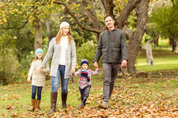 istock Young family running in leaves 664004330