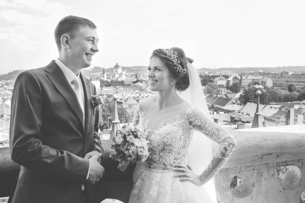 istock Wedding couple smiling to each other on stone balcony 664008094