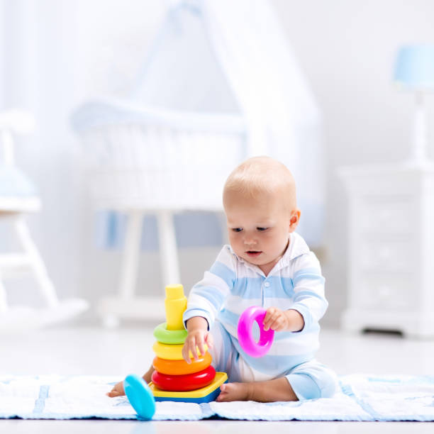 istock Baby playing with toy pyramid. Kids play 664010836