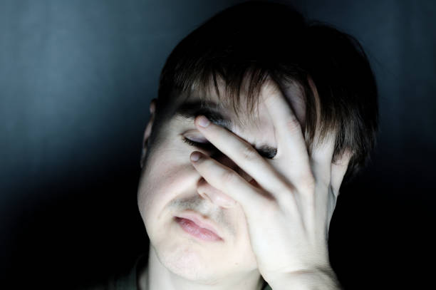 istock stressed man holding head feeling headache portrait 664011528