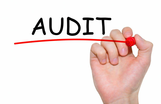 istock Hand writing Audit, with red marker on transparent wipe board. 664013052