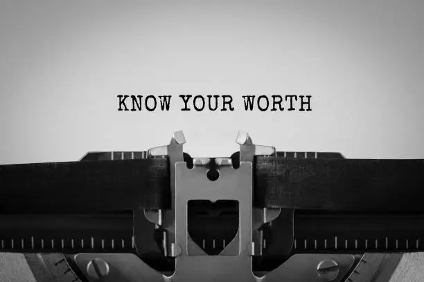Photo of Text Know Your Worth typed on retro typewriter