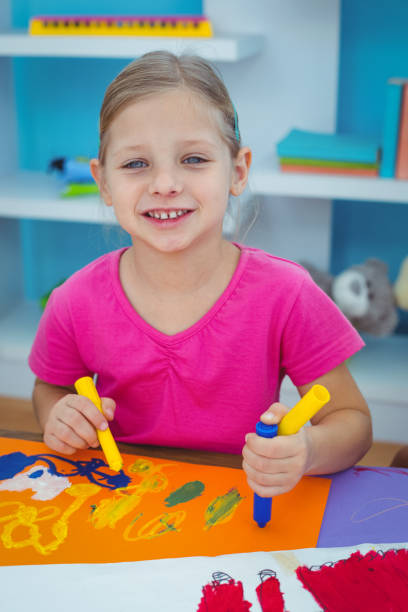 istock Children drawing on coloured paper 664015744