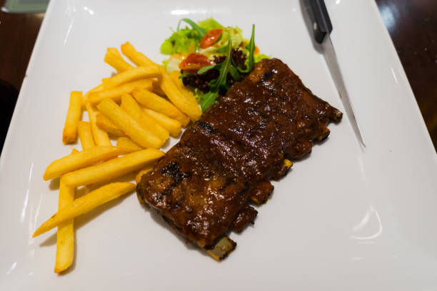istock Roasted sliced barbecue pork ribs, focus on sliced meat 664015948