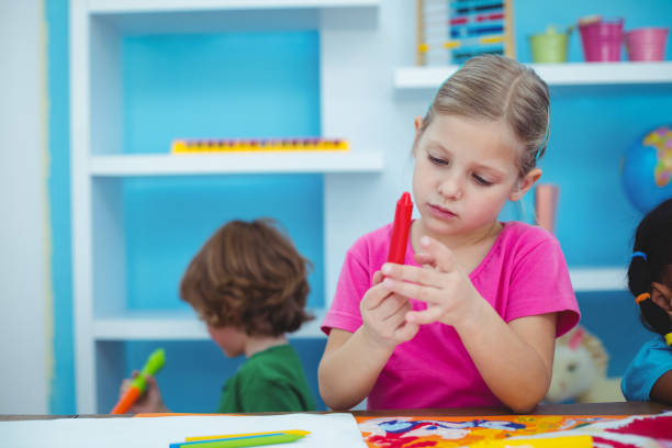 istock Small girl holding a red crayon 664018910