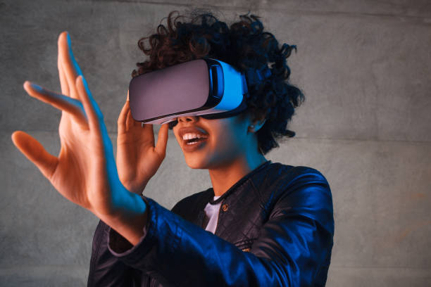 istock Surprised woman in VR headset touching air 664018966