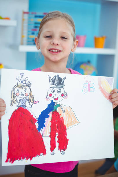 istock Small girl holding a lovely drawing 664018994