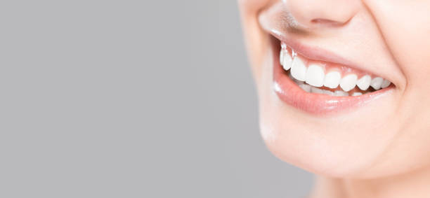 istock Beautiful smile young woman. White teeth on the master plan. 664019360