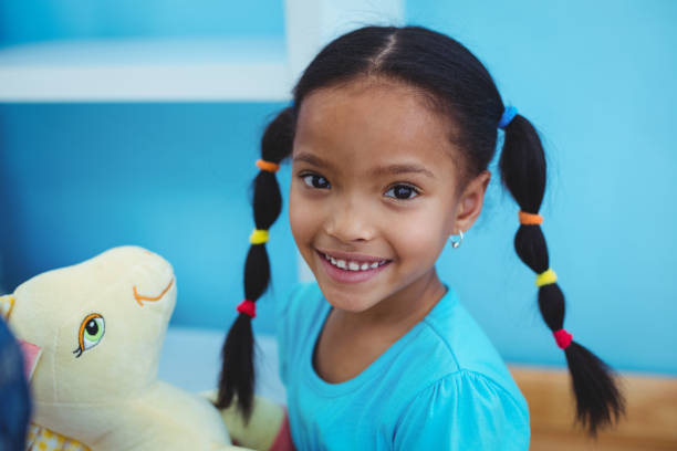 istock Small girl holding a pony teddy 664022438