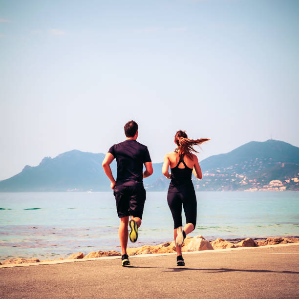 Man and woman jogging at the seashore