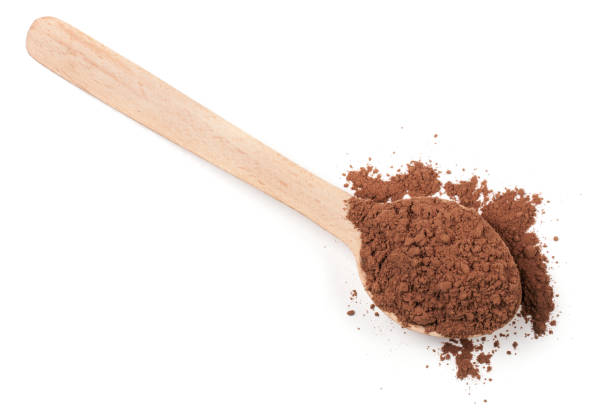 istock cocoa powder in a wooden spoon isolated on white background 664026334