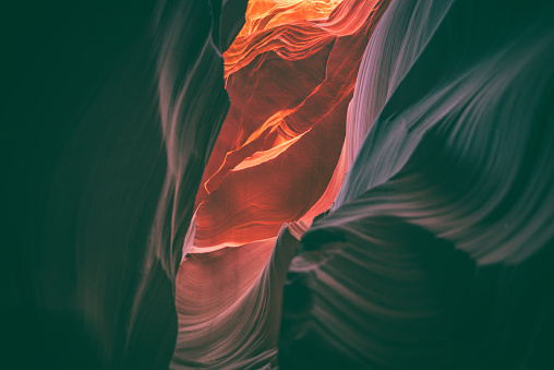 An abstract photo from inside lower Antelope Canyon in Page Arizona USA that is located nearby Grand Canyon and Glen Canyon. It shows the beautiful shapes, wave patterns and colors of the canyon.