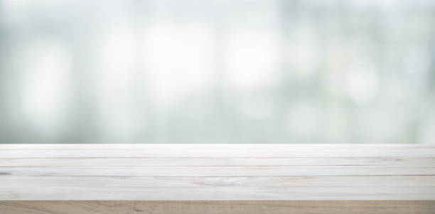 Wood table top on glass wall abstract background.