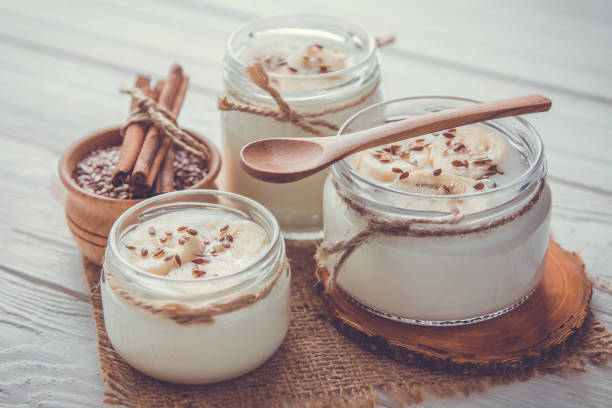 istock Yogurt in glass jars on wooden background 664029988