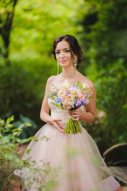 istock Portrait of a beautiful bride in park 664033360