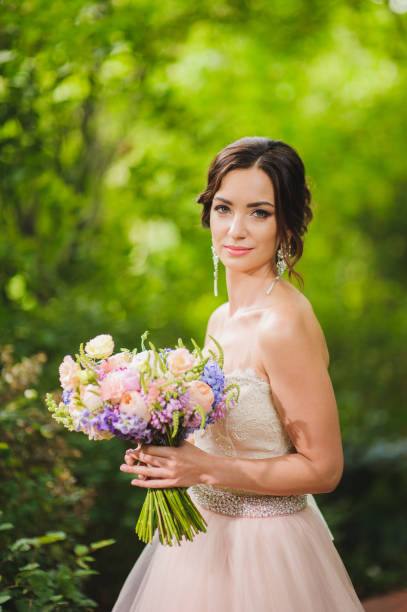 istock Portrait of a beautiful bride in park 664035584