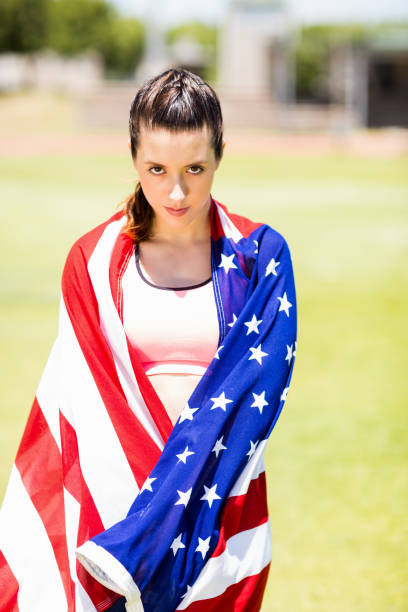 istock Female athlete wrapped in american flag 664037654