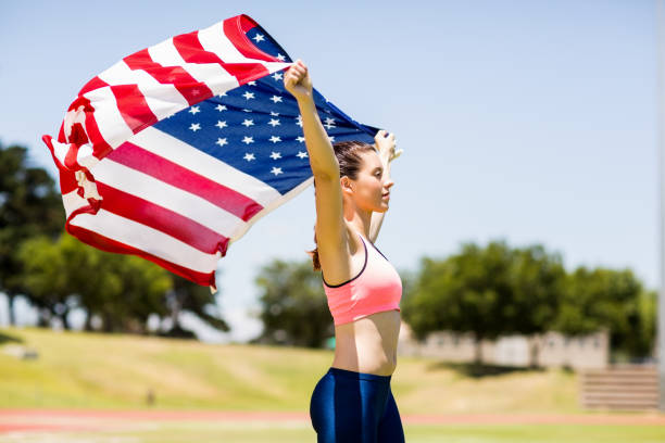 istock Female athlete holding an american flag 664039352