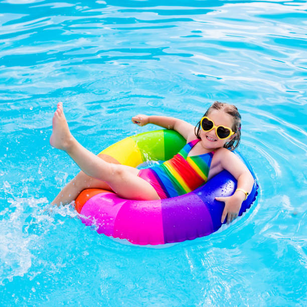 istock Child with toy ring in swimming pool 664039694
