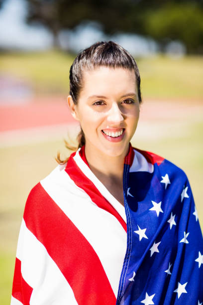 istock Female athlete wrapped in american flag 664039748