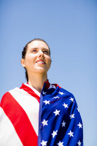 istock Female athlete wrapped in american flag 664039846