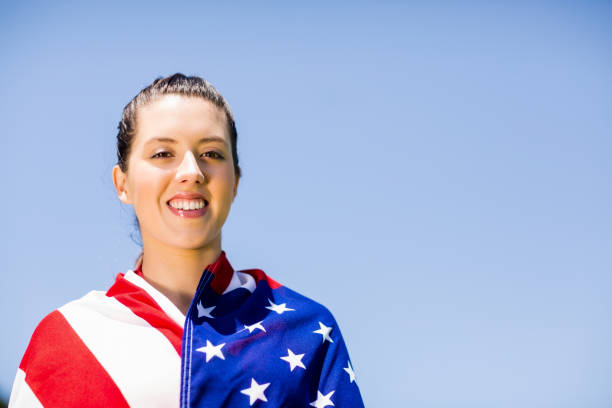 istock Female athlete wrapped in american flag 664039928