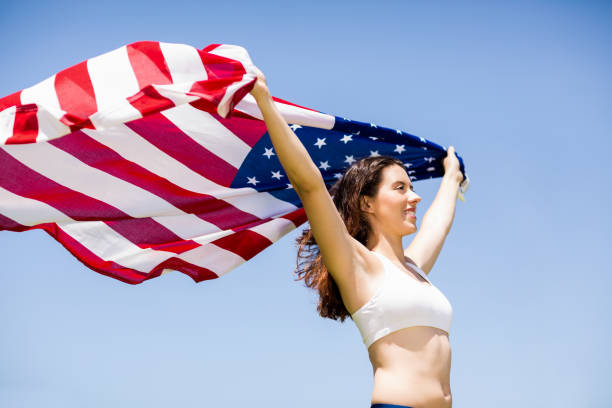 istock Female athlete holding an american flag 664039988