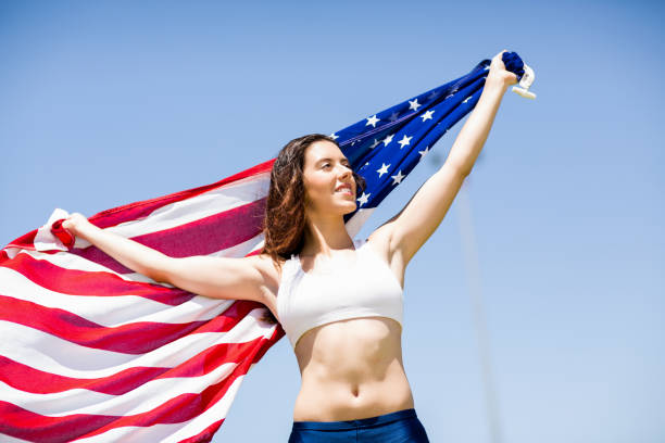 Female athlete holding an american flag