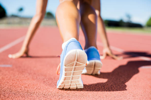 istock Female athlete ready to run on running track 664040148