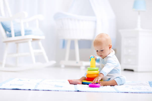 istock Baby playing with toy pyramid. Kids play 664040544