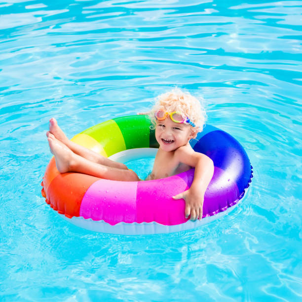 istock Child with toy ring in swimming pool 664042782