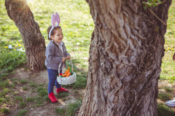 istock Girl near tree searching for eggs 664043736