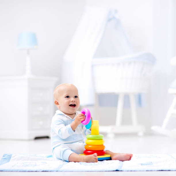 istock Baby playing with toy pyramid. Kids play 664046470