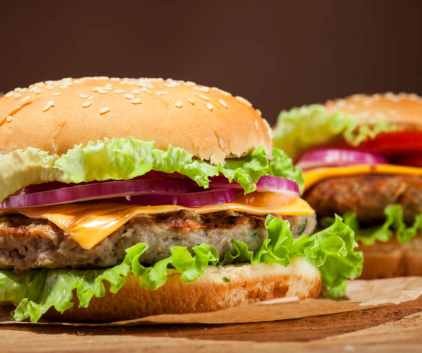 istock Fresh burgers on wooden background 664048126
