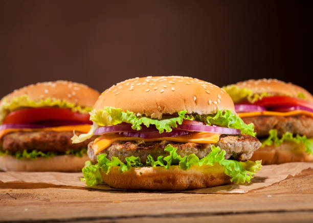Fresh burgers on wooden background