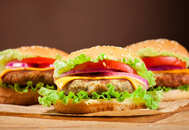 istock Fresh burgers on wooden background 664048134