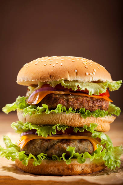 istock Fresh burger on wooden background 664048136