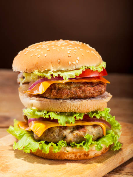istock Fresh burger on wooden background 664048144
